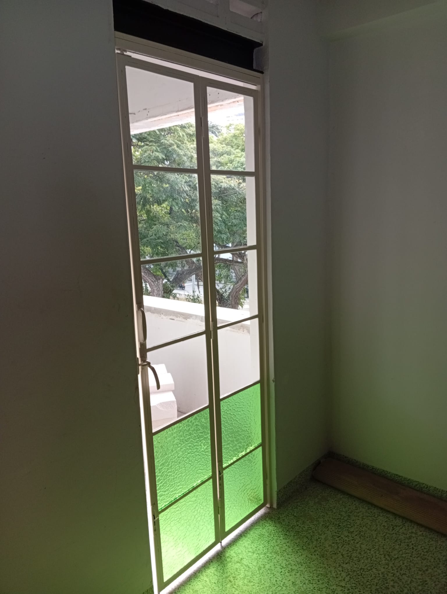 Tall glazed door with white framing at Guan Chuan
